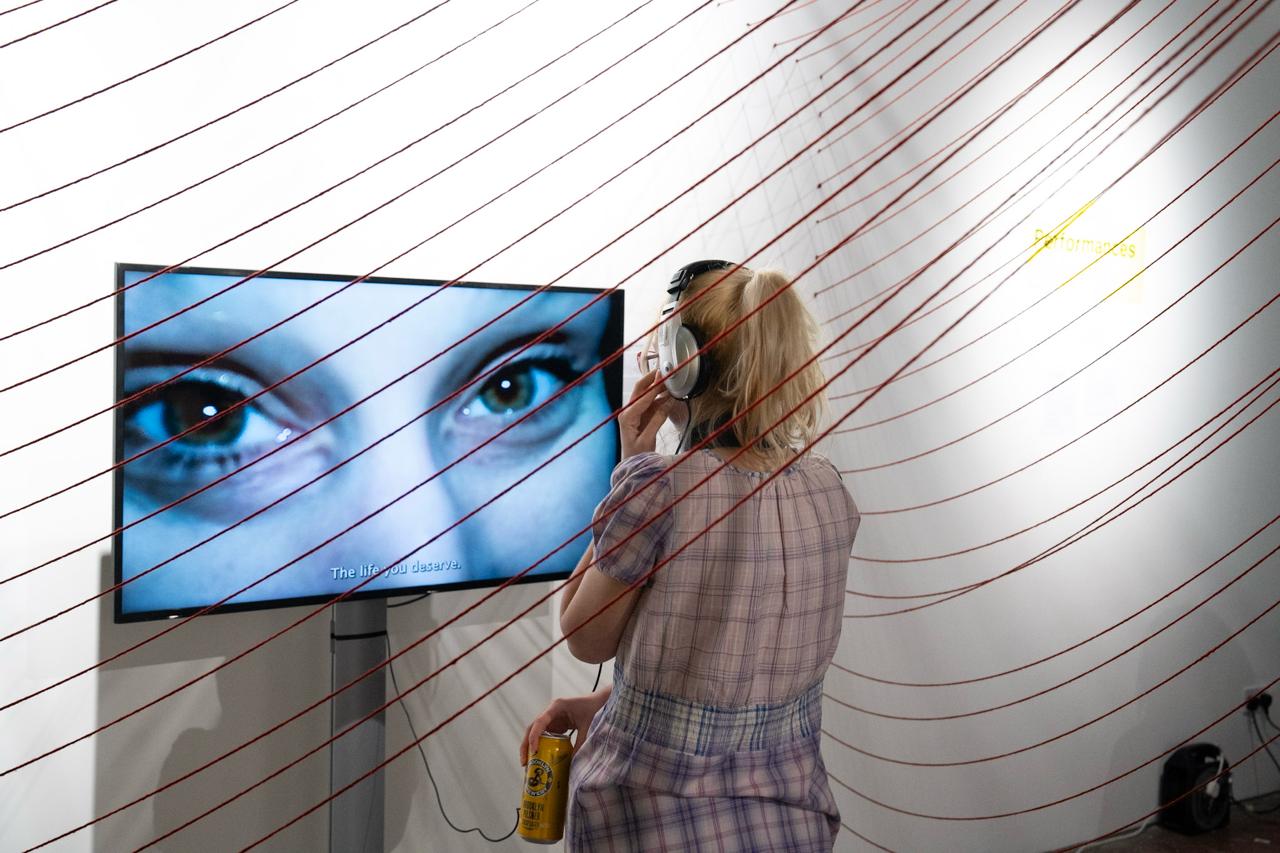 R.E.S.T.A.G.E — visitor with headphones