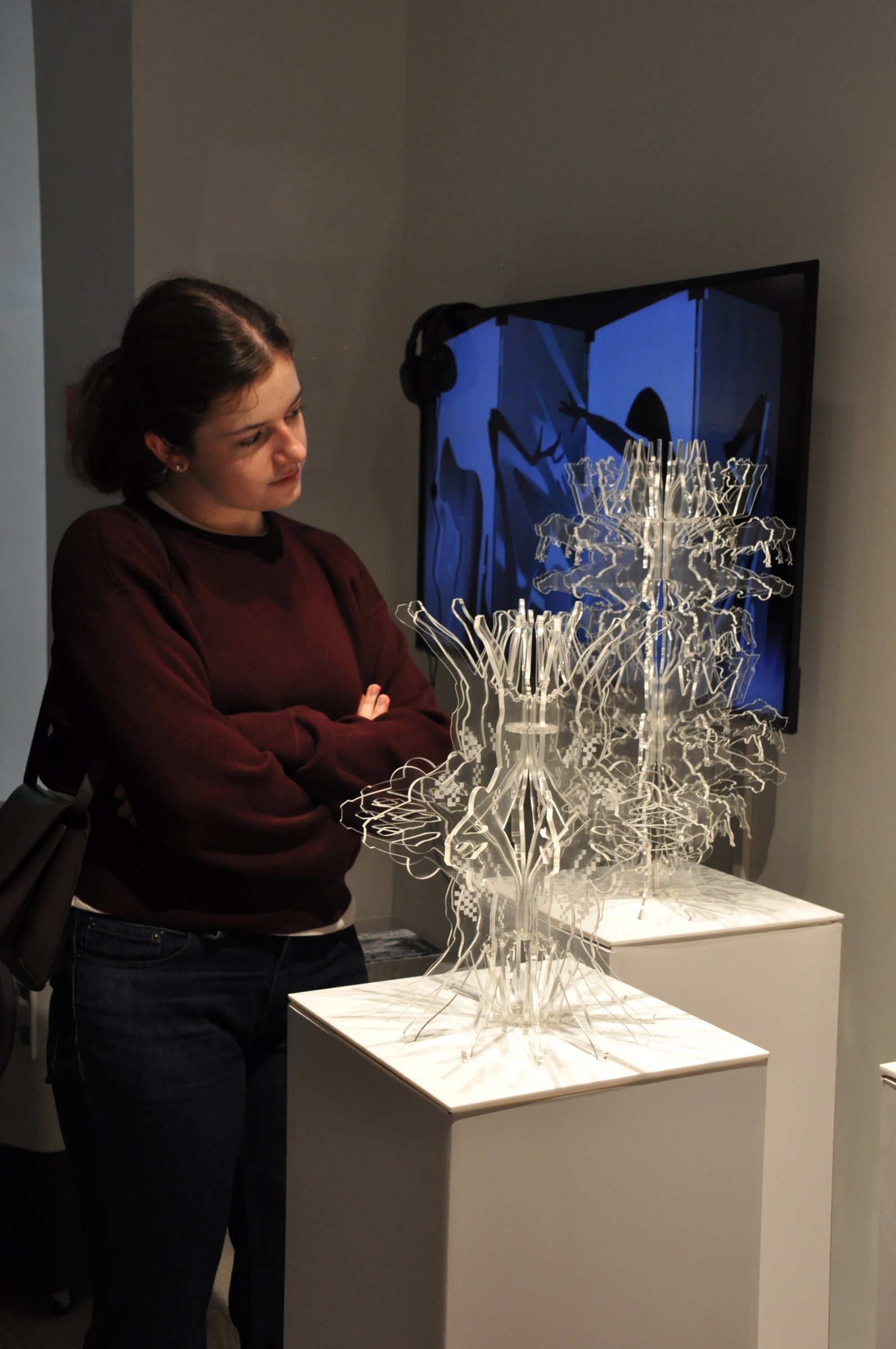 Visitor viewing the sculptures and their moving-image development process